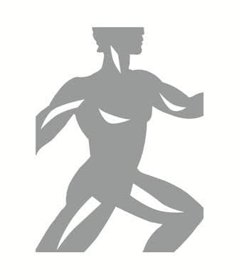 Aerial view of sports fields and building surrounded by trees