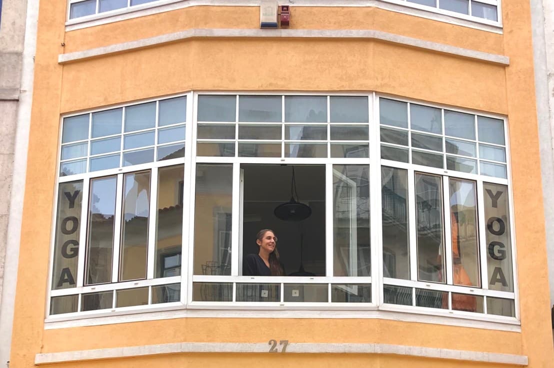 Person meditating in a yoga studio