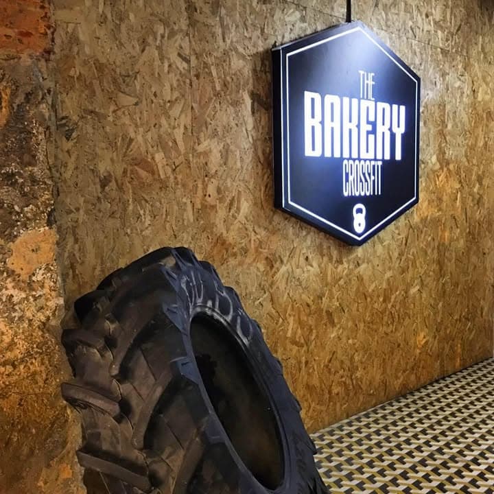 CrossFit box with barbells and equipment