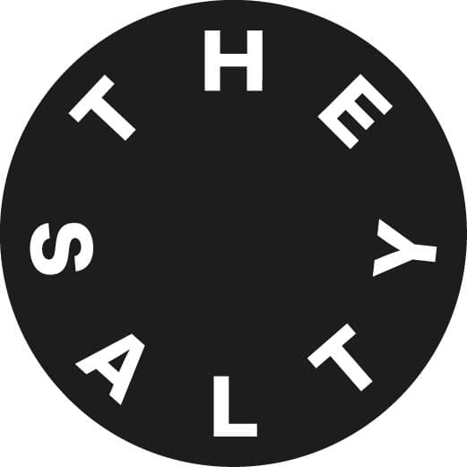 Surfer riding a wave at sunset